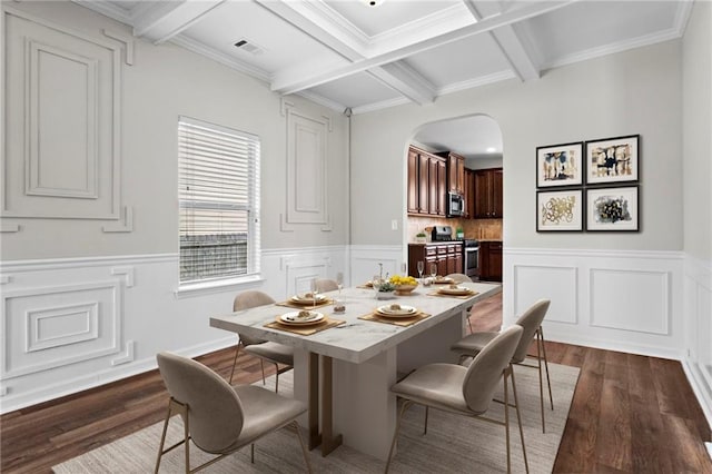 dining room featuring arched walkways, visible vents, dark wood-style flooring, and beamed ceiling