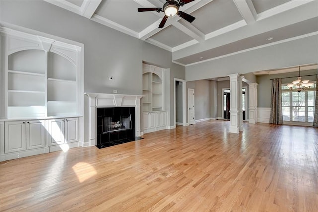 5195 Stefan Ridge Way, Buford, GA 30519 - unfurnished living room with ornate columns, a tiled fireplace, light wood-type flooring, ceiling fan, and beamed ceiling