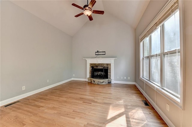 5195 Stefan Ridge Way, Buford, GA 30519 - unfurnished living room featuring a stone fireplace, light wood-style floors, visible vents, and ceiling fan