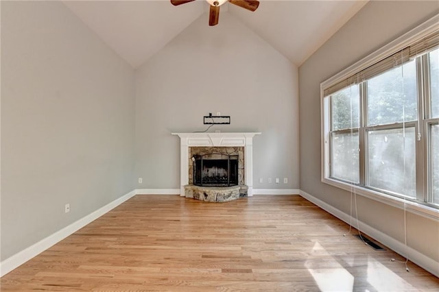 5195 Stefan Ridge Way, Buford, GA 30519 - unfurnished living room featuring light wood finished floors, a ceiling fan, high vaulted ceiling, a fireplace, and baseboards