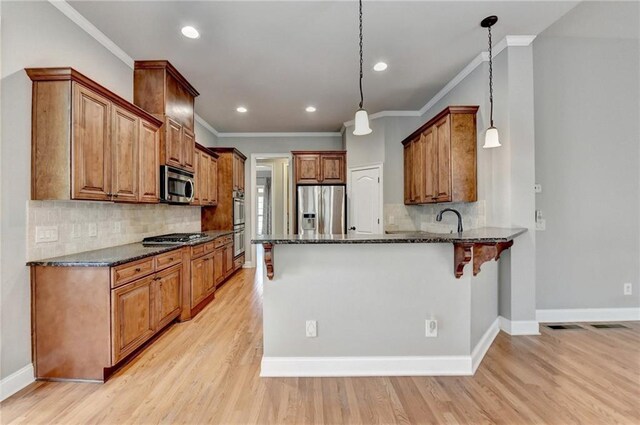 5195 Stefan Ridge Way, Buford, GA 30519 - kitchen featuring a peninsula, crown molding, appliances with stainless steel finishes, and dark stone countertops