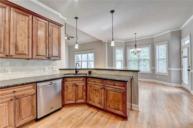 5195 Stefan Ridge Way, Buford, GA 30519 - kitchen with a sink, a peninsula, brown cabinetry, dishwasher, and light wood-style floors