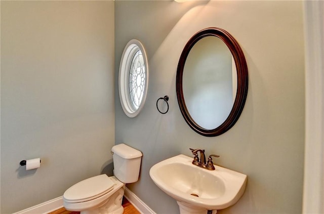 5195 Stefan Ridge Way, Buford, GA 30519 - half bathroom featuring toilet, baseboards, and a sink