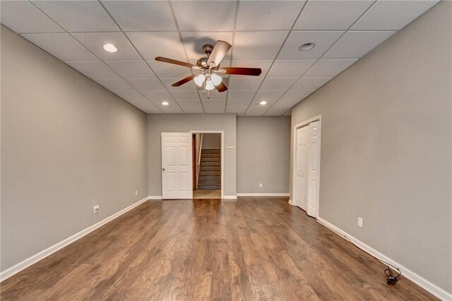 5195 Stefan Ridge Way, Buford, GA 30519 - unfurnished room featuring stairway, ceiling fan, dark wood-style floors, a paneled ceiling, and baseboards