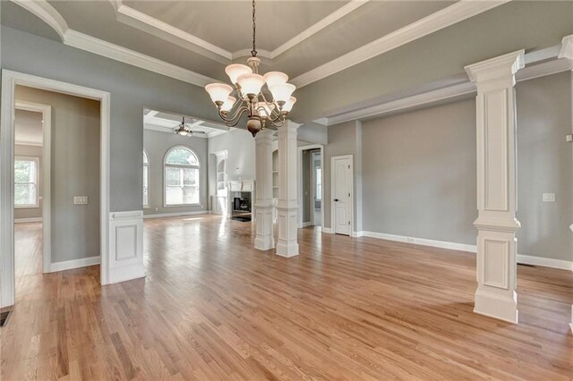 5195 Stefan Ridge Way, Buford, GA 30519 - unfurnished living room featuring ornamental molding, light wood-type flooring, baseboards, and ornate columns
