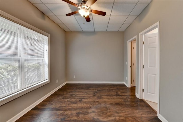 5195 Stefan Ridge Way, Buford, GA 30519 - spare room featuring dark wood finished floors, baseboards, ceiling fan, and a paneled ceiling