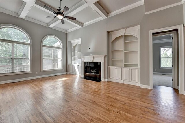 5195 Stefan Ridge Way, Buford, GA 30519 - unfurnished living room featuring light wood-type flooring, baseboards, ceiling fan, and built in shelves