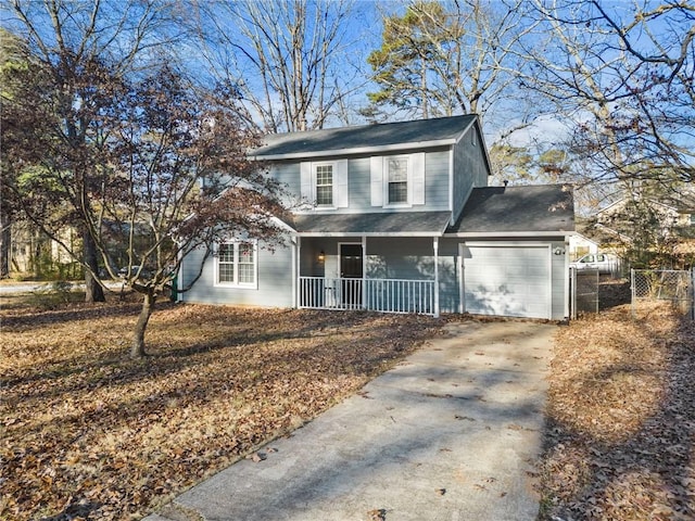 view of property featuring covered porch and a garage