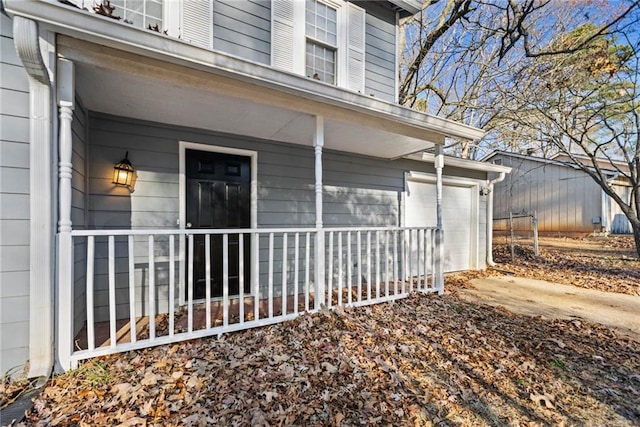 view of home's exterior featuring covered porch and a garage