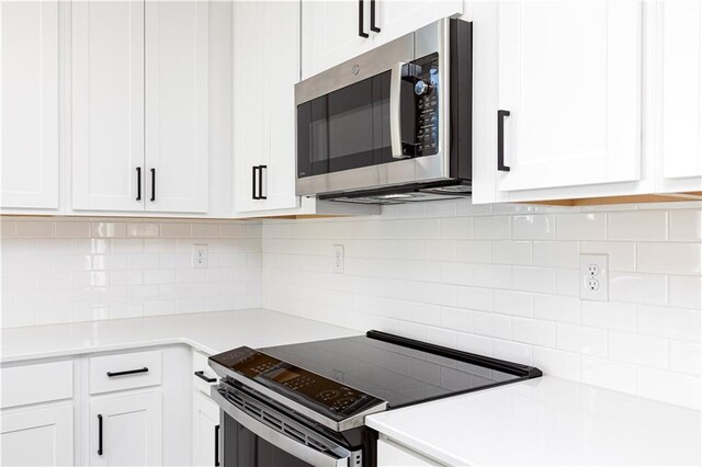 kitchen featuring a kitchen island with sink, sink, dark hardwood / wood-style floors, appliances with stainless steel finishes, and decorative light fixtures