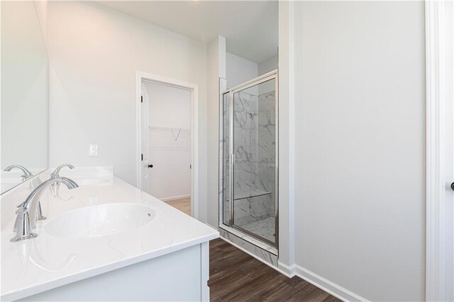 bathroom featuring hardwood / wood-style floors and a shower with shower door