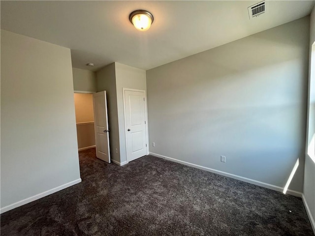 unfurnished bedroom featuring dark carpet