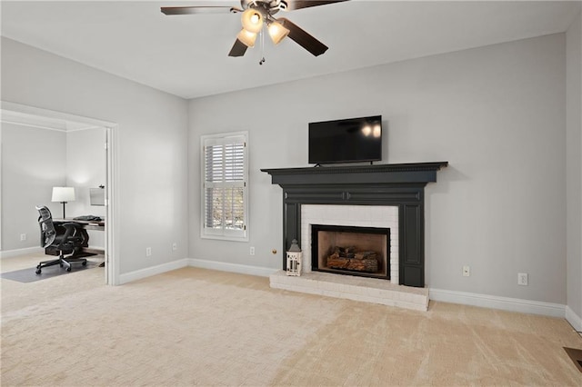 unfurnished living room featuring light carpet, ceiling fan, a fireplace, and baseboards