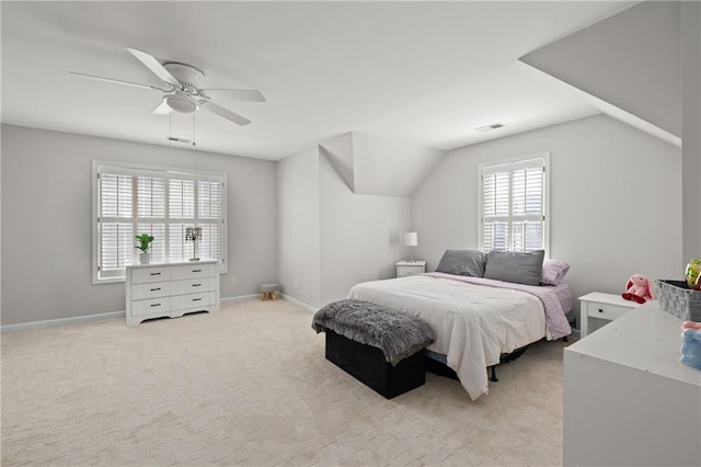 bedroom featuring baseboards, visible vents, light colored carpet, lofted ceiling, and ceiling fan