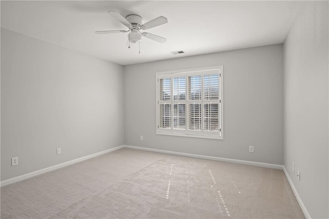 unfurnished room featuring baseboards, light colored carpet, visible vents, and a ceiling fan