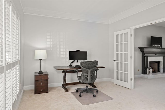 office area featuring light carpet, a brick fireplace, baseboards, and ornamental molding