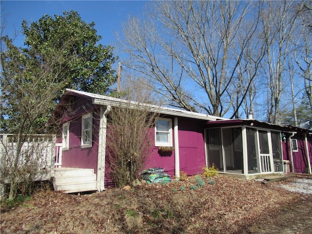 back of property with a sunroom