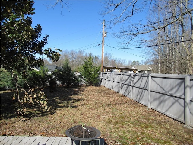 view of yard with a fire pit