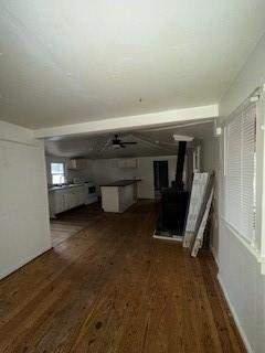 1786 Camp Wahsega Rd, Dahlonega, GA 30533 - unfurnished living room featuring a wood stove, wood finished floors, and ceiling fan