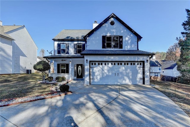 view of front facade with covered porch, a garage, and a front yard