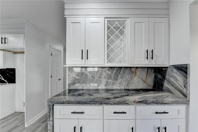 interior space with stone counters and white cabinets