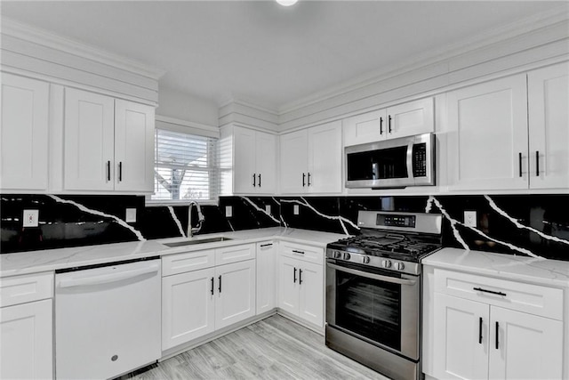 kitchen featuring sink, white cabinets, and appliances with stainless steel finishes