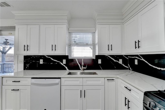 kitchen featuring backsplash, white dishwasher, sink, light stone countertops, and white cabinetry