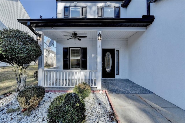 doorway to property featuring ceiling fan and covered porch