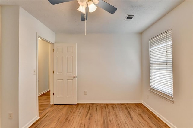 unfurnished room with ceiling fan and light hardwood / wood-style floors