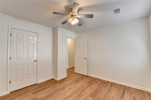 unfurnished bedroom with light wood-type flooring and ceiling fan