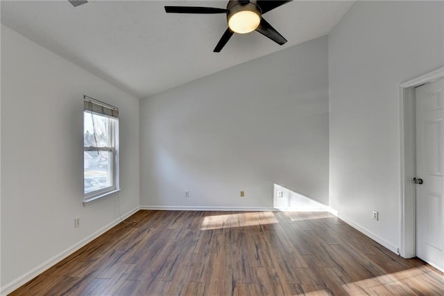 empty room featuring lofted ceiling, ceiling fan, and dark hardwood / wood-style floors