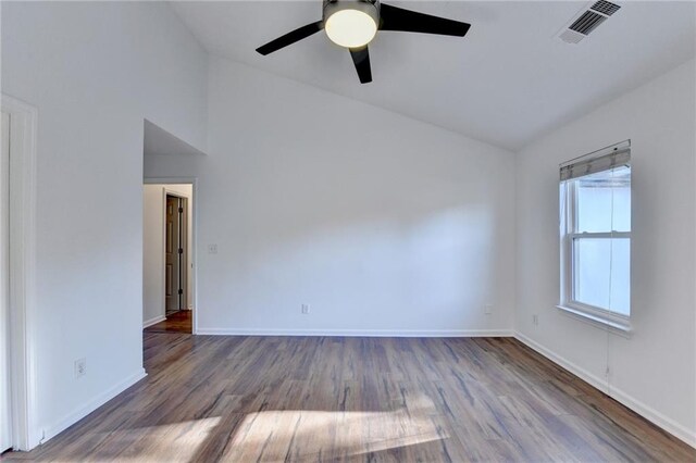 empty room with ceiling fan, vaulted ceiling, and hardwood / wood-style flooring