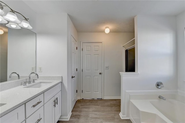 bathroom featuring a bath, vanity, and hardwood / wood-style flooring