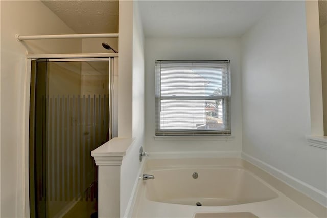 bathroom featuring shower with separate bathtub