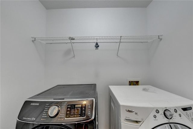 clothes washing area with independent washer and dryer