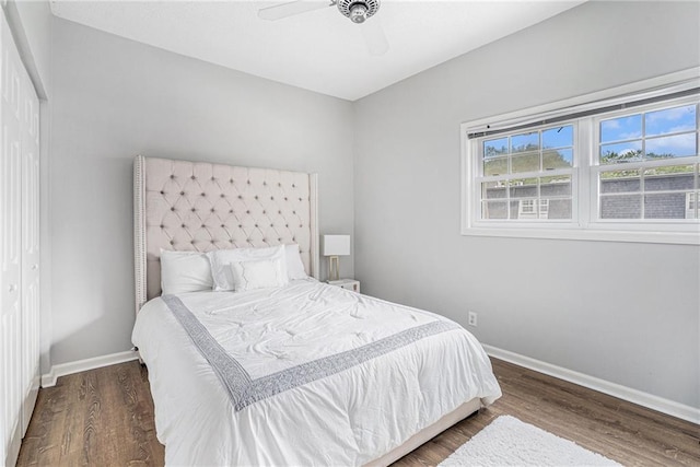 bedroom featuring baseboards, wood finished floors, and ceiling fan
