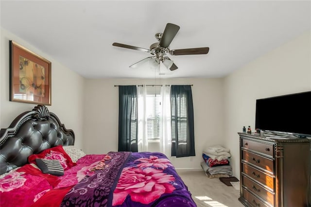bedroom with a ceiling fan and carpet