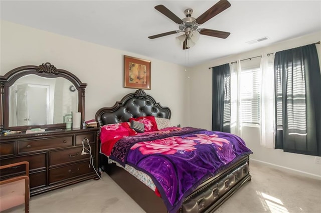 bedroom with visible vents, baseboards, ceiling fan, and light colored carpet