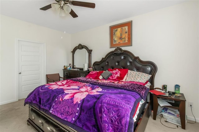 carpeted bedroom with baseboards and a ceiling fan
