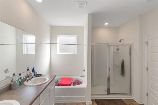 full bath with a stall shower, a garden tub, a sink, and visible vents