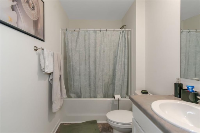 bathroom with shower / bathtub combination with curtain, vanity, and toilet