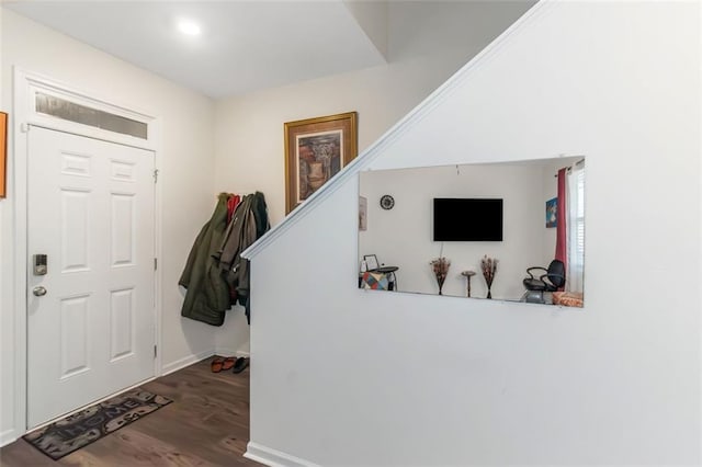 foyer with baseboards, stairway, and wood finished floors