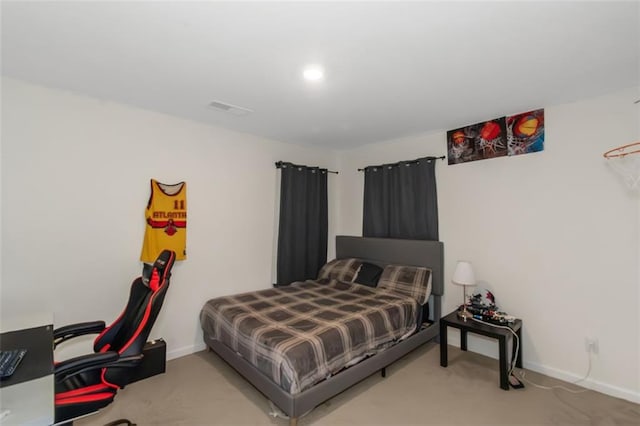 carpeted bedroom with visible vents and baseboards