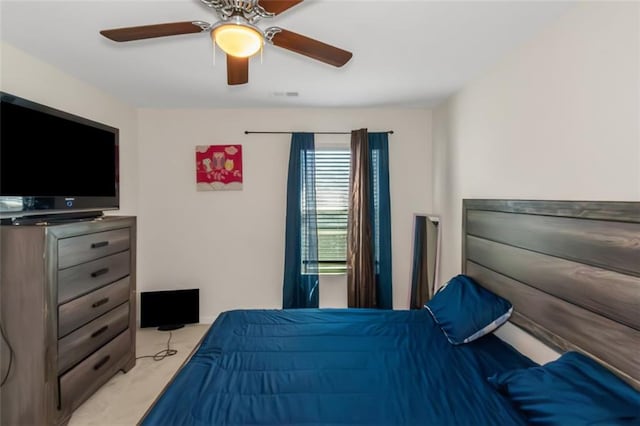 bedroom featuring light carpet, visible vents, and ceiling fan