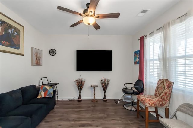 living room with wood finished floors, ceiling fan, visible vents, and a wealth of natural light