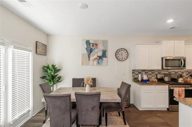 dining room featuring dark wood-type flooring, visible vents, and recessed lighting