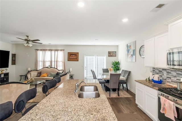 kitchen featuring appliances with stainless steel finishes, a sink, visible vents, and a wealth of natural light