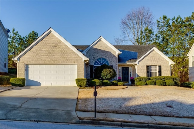 view of front of home featuring concrete driveway, brick siding, and a garage