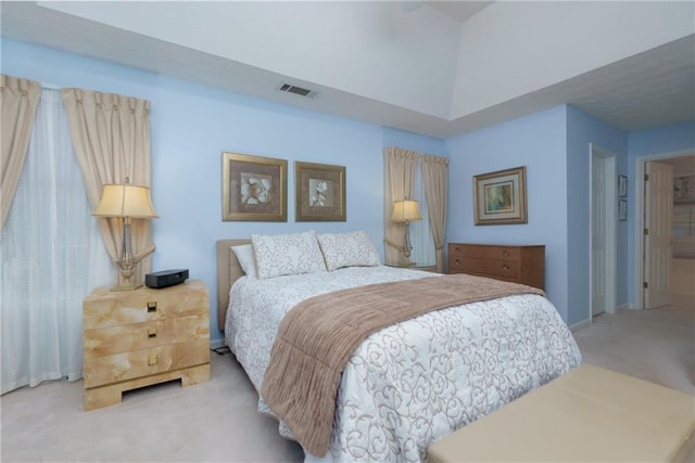 carpeted bedroom with visible vents and baseboards