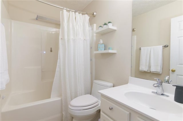 bathroom with toilet, vanity, a textured ceiling, and shower / tub combo